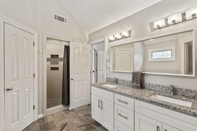 bathroom with lofted ceiling, a stall shower, a sink, and visible vents