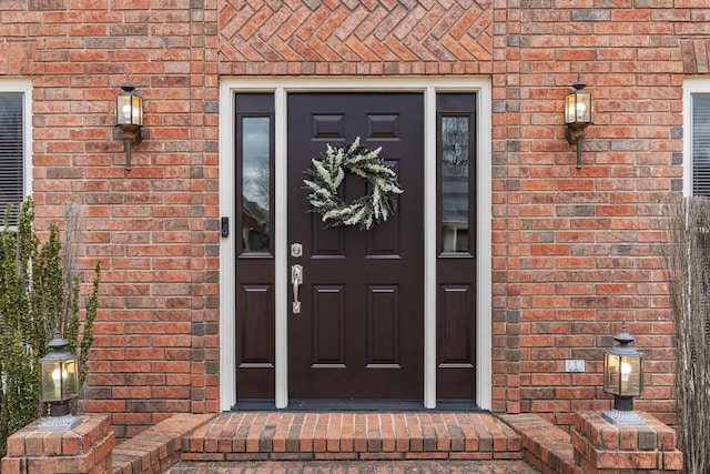 doorway to property with brick siding