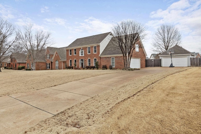 colonial-style house with fence and brick siding