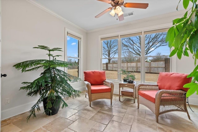 sitting room featuring a healthy amount of sunlight, visible vents, baseboards, and crown molding