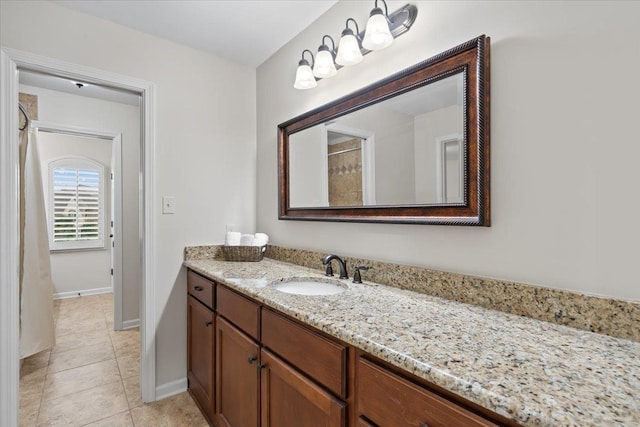 bathroom featuring a shower with curtain, tile patterned flooring, vanity, and baseboards