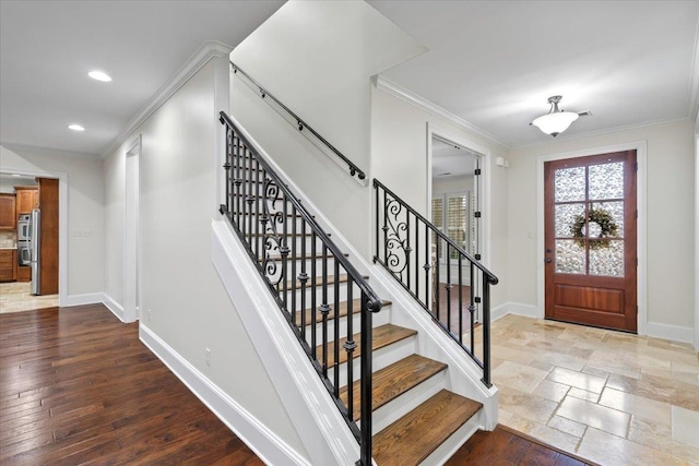 entrance foyer featuring recessed lighting, baseboards, wood finished floors, and ornamental molding