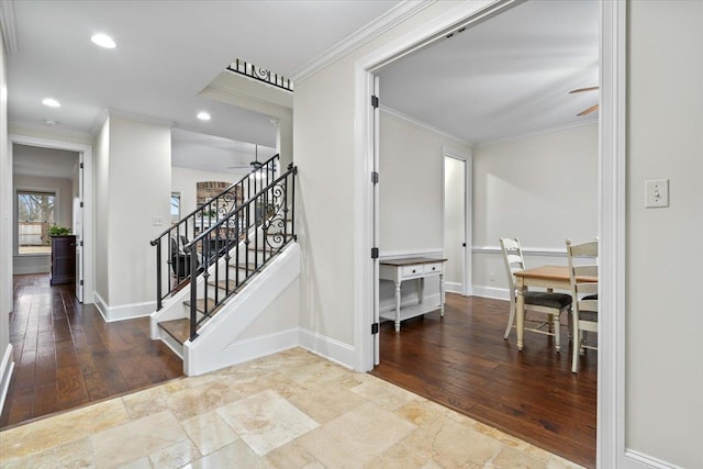 interior space with ornamental molding, ceiling fan, and baseboards