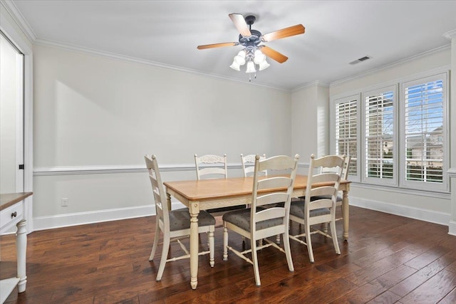 dining space with visible vents, baseboards, dark wood finished floors, and crown molding