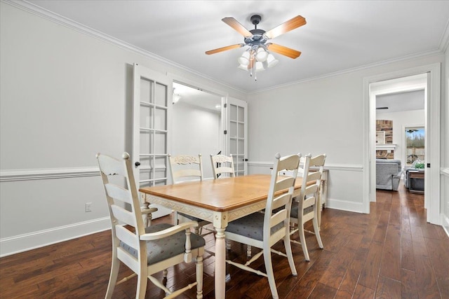 dining room with french doors, ornamental molding, ceiling fan, baseboards, and hardwood / wood-style flooring