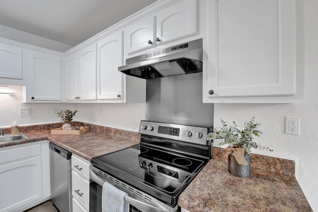 kitchen with under cabinet range hood, white cabinetry, appliances with stainless steel finishes, and a textured wall