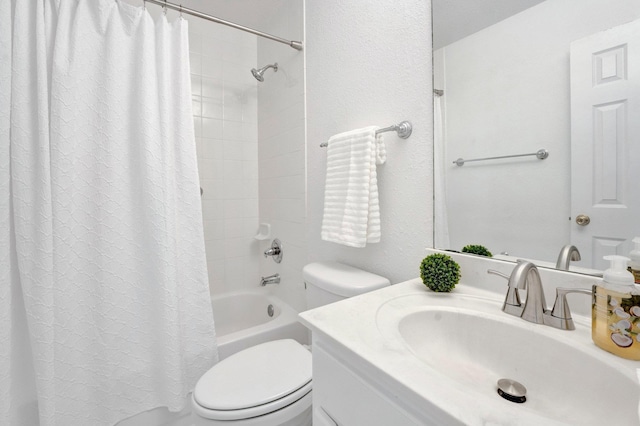 bathroom with toilet, shower / bath combo, and vanity