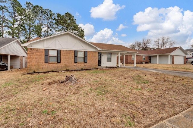 ranch-style home featuring a front yard and brick siding