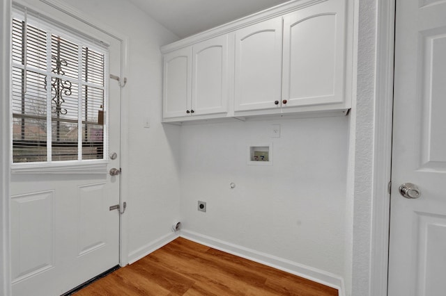 clothes washing area with cabinet space, baseboards, wood finished floors, washer hookup, and electric dryer hookup