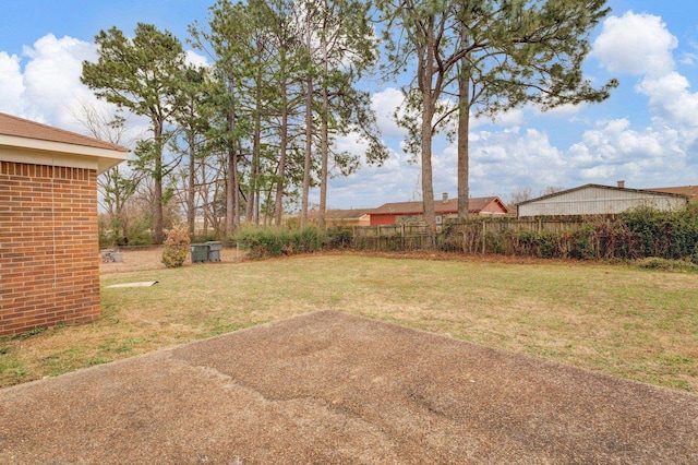 view of yard featuring fence and a patio