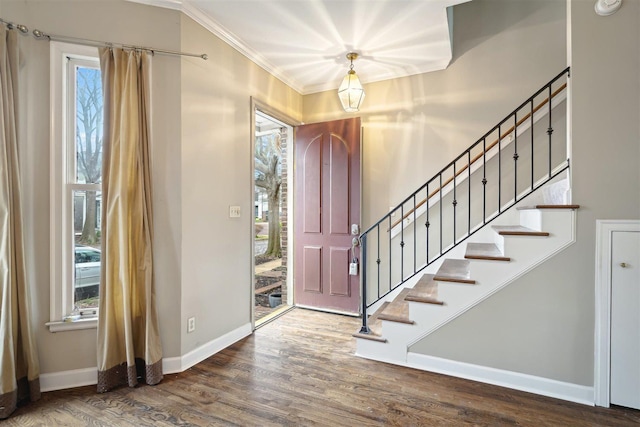 entrance foyer with stairway, baseboards, wood finished floors, and ornamental molding