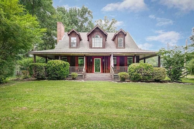 farmhouse featuring a chimney, a porch, and a front yard