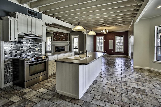 kitchen with electric range, open floor plan, under cabinet range hood, white cabinetry, and a sink