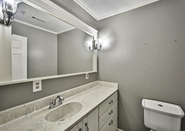 half bath with ornamental molding, visible vents, vanity, and toilet