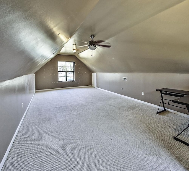 additional living space featuring lofted ceiling, carpet flooring, visible vents, and baseboards