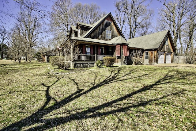 view of front of home featuring a garage, covered porch, and a front lawn