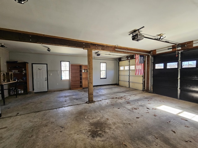 garage featuring a garage door opener and baseboards