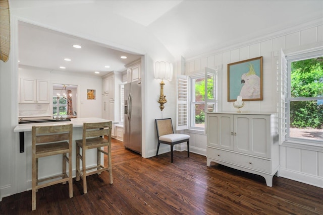 living area with a notable chandelier, crown molding, dark wood-style flooring, and recessed lighting