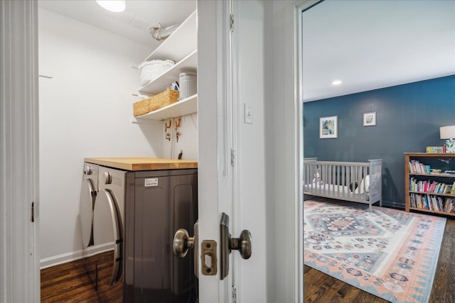 washroom featuring laundry area, dark wood-style flooring, washer / dryer, and baseboards