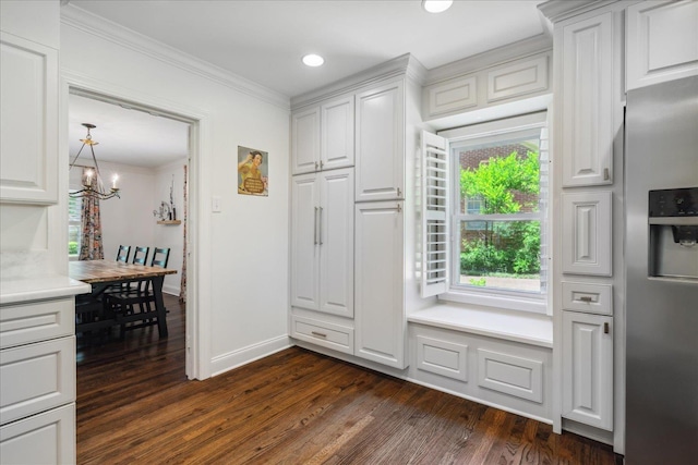 kitchen featuring dark wood-type flooring, white cabinetry, stainless steel fridge with ice dispenser, an inviting chandelier, and crown molding