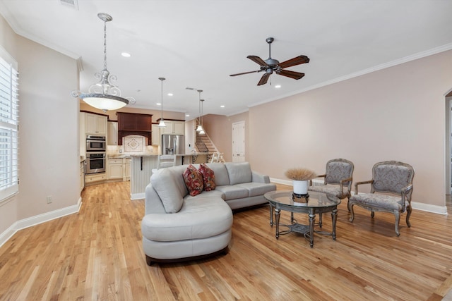 living area featuring ornamental molding, stairway, light wood-style flooring, and baseboards