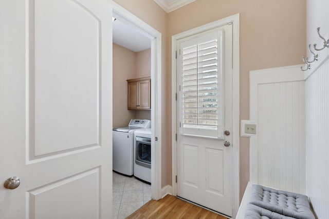 clothes washing area with cabinet space and independent washer and dryer