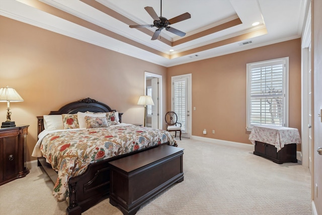 bedroom with light carpet, visible vents, baseboards, a raised ceiling, and crown molding