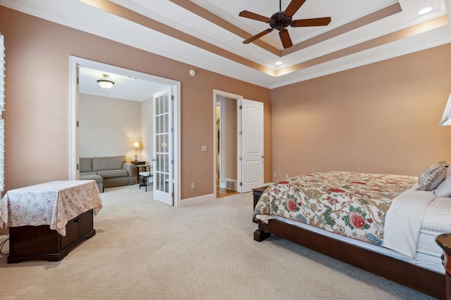 bedroom with light carpet, baseboards, a tray ceiling, crown molding, and french doors