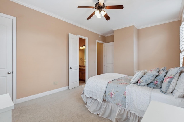 bedroom with light carpet, baseboards, crown molding, and ensuite bathroom