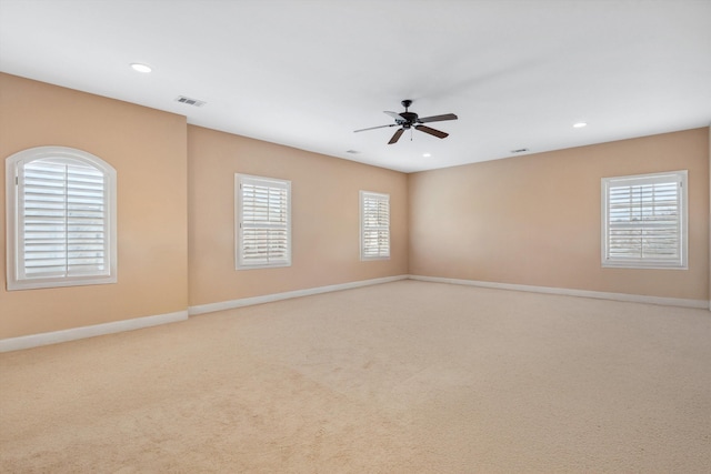 carpeted spare room with recessed lighting, visible vents, and baseboards