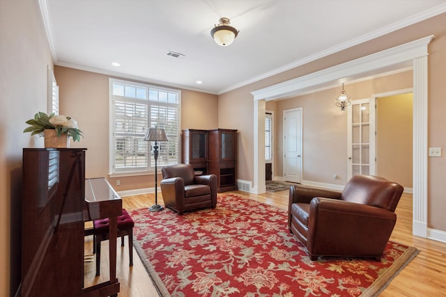 living area with recessed lighting, wood finished floors, visible vents, baseboards, and ornamental molding