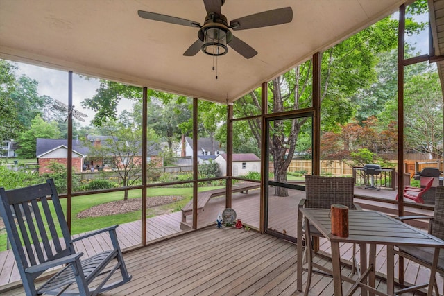 sunroom with a wealth of natural light and a ceiling fan