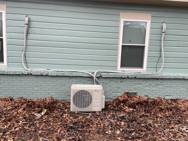 exterior details featuring crawl space, ac unit, and brick siding