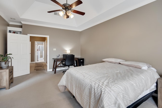 bedroom with light carpet, a tray ceiling, visible vents, and baseboards