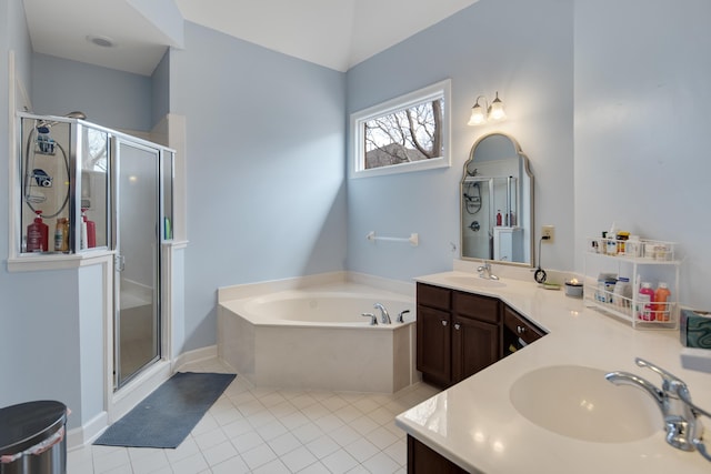 full bath with a stall shower, a sink, and double vanity