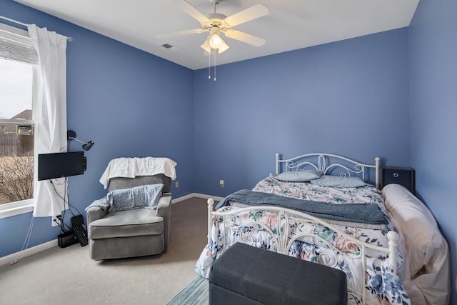 carpeted bedroom featuring visible vents, baseboards, and a ceiling fan