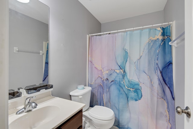 full bath featuring toilet, a shower with shower curtain, and vanity