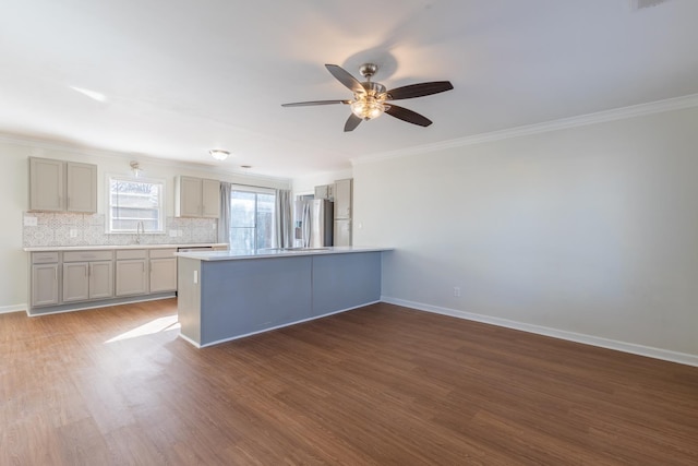 kitchen featuring wood finished floors, baseboards, backsplash, gray cabinets, and stainless steel fridge with ice dispenser