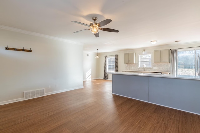 interior space with tasteful backsplash, visible vents, wood finished floors, light countertops, and gray cabinetry