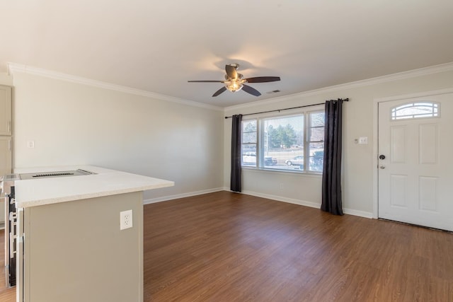 interior space featuring ceiling fan, crown molding, baseboards, and wood finished floors