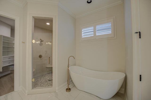 full bathroom with baseboards, a freestanding bath, marble finish floor, ornamental molding, and a stall shower