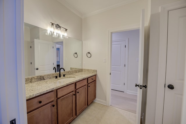 bathroom featuring baseboards, tile patterned flooring, vanity, and crown molding