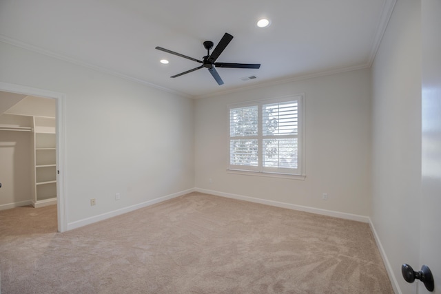 carpeted empty room featuring recessed lighting, visible vents, ornamental molding, ceiling fan, and baseboards