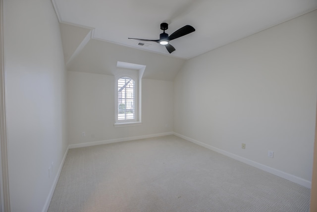 interior space with ceiling fan, lofted ceiling, visible vents, and baseboards