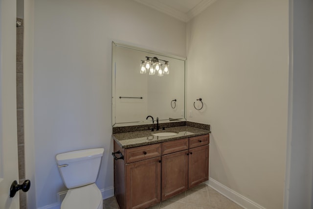 bathroom featuring toilet, ornamental molding, vanity, tile patterned flooring, and baseboards