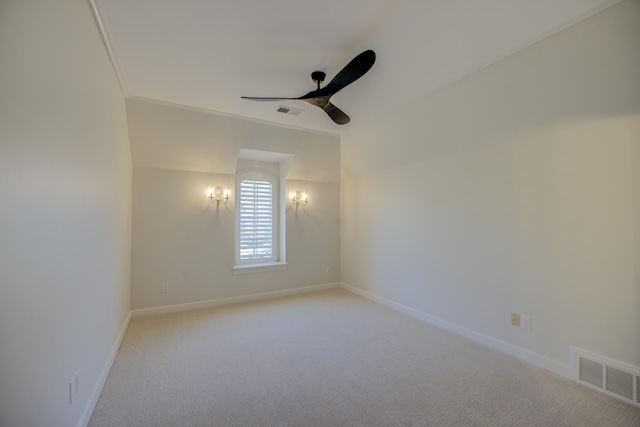 empty room with light carpet, ceiling fan, visible vents, and baseboards