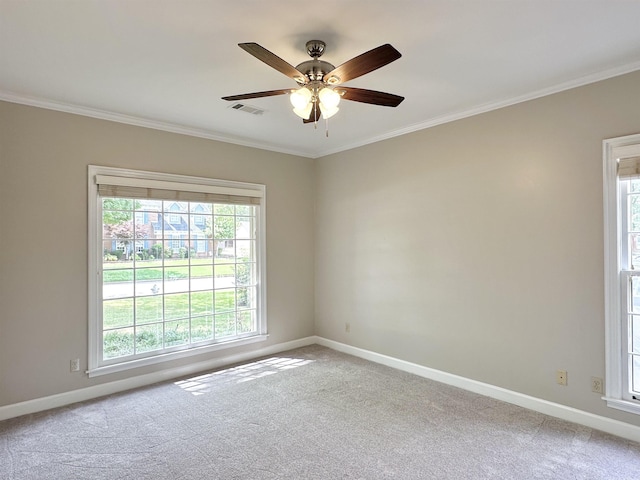 spare room with light carpet, baseboards, visible vents, and crown molding