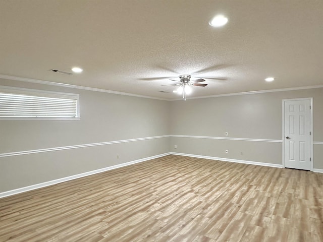 empty room with baseboards, visible vents, ceiling fan, and light wood finished floors