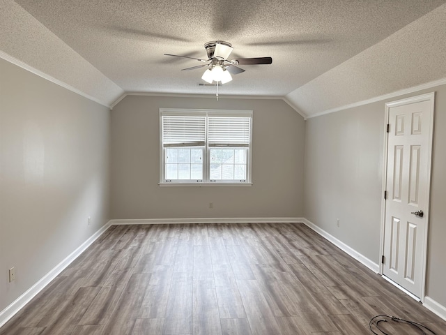 bonus room featuring dark wood-type flooring, lofted ceiling, baseboards, and a ceiling fan