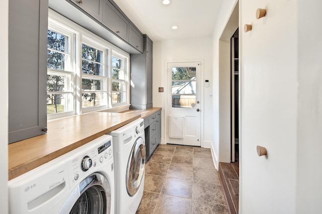 laundry room with stone finish floor, washer and clothes dryer, cabinet space, and recessed lighting